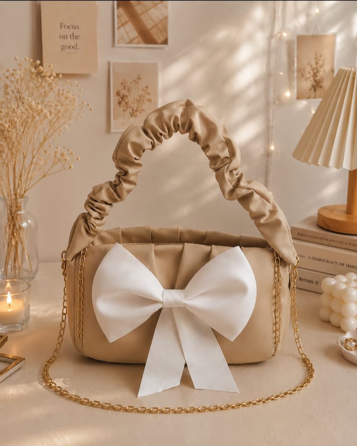 Elegant Beige Shoulder Bag with White Bow & Gold Chain.