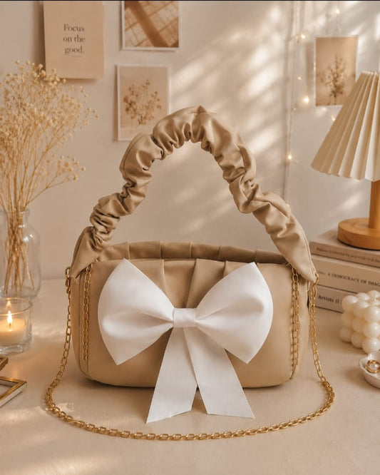 Elegant Beige Shoulder Bag with White Bow & Gold Chain.